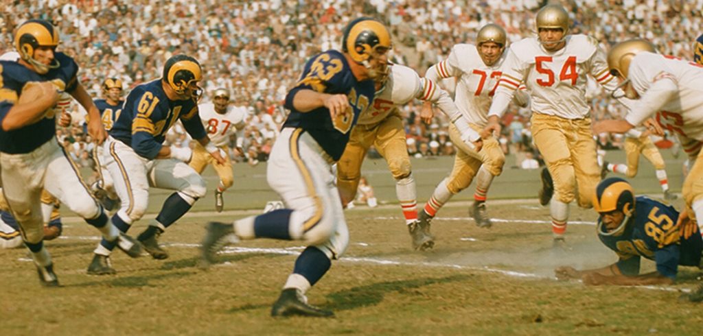 A 1950s action photo of offensive lineman John Hock (Number 63) plying his trade for the Los Angeles Rams.