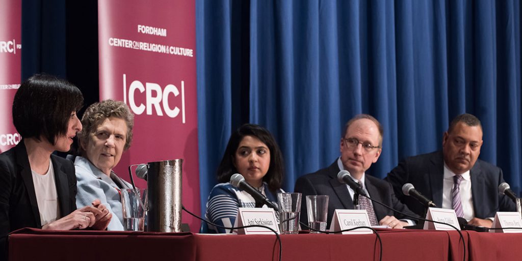 Ani Sarkissian, Carol Keehan, Asma Uddin, Thomas Berg, and Vincent D. Rougeau, sitting at a table on stage at the Pope Auditorium, at Fordham's Lincoln Center campus