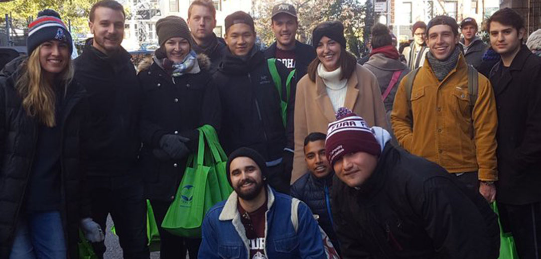 Fordham young alumni handing out care bags at a volunteer event