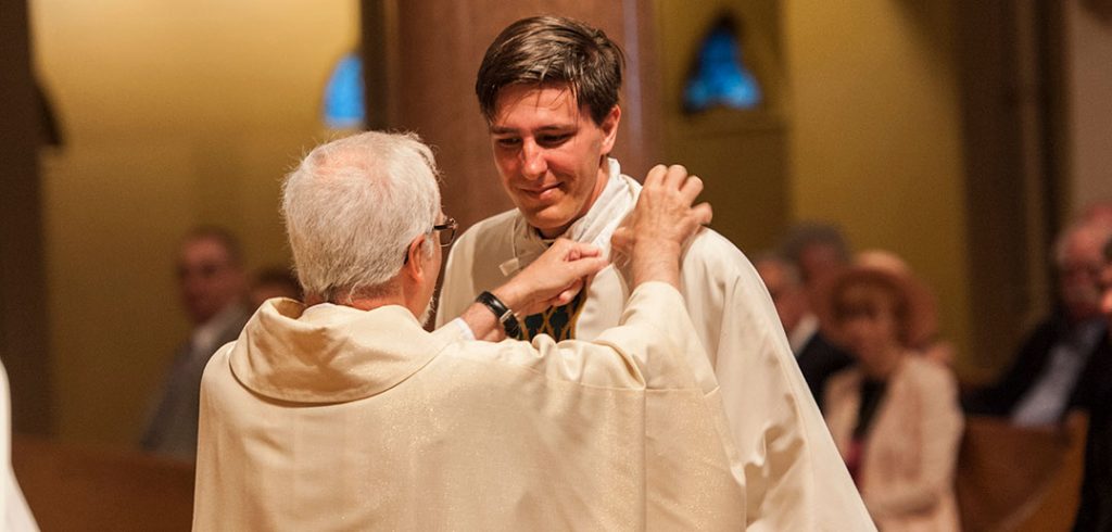 David C. Paternostro, S.J., is shown being vested at his ordination on June 9.