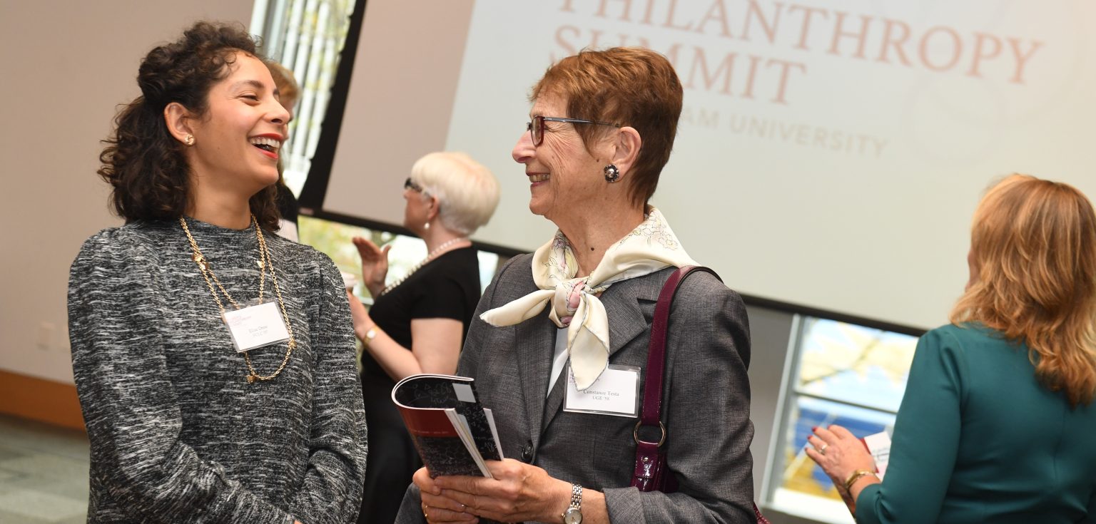 Two women share a conversation at the inaugural Women's Philanthropy Summit last year.