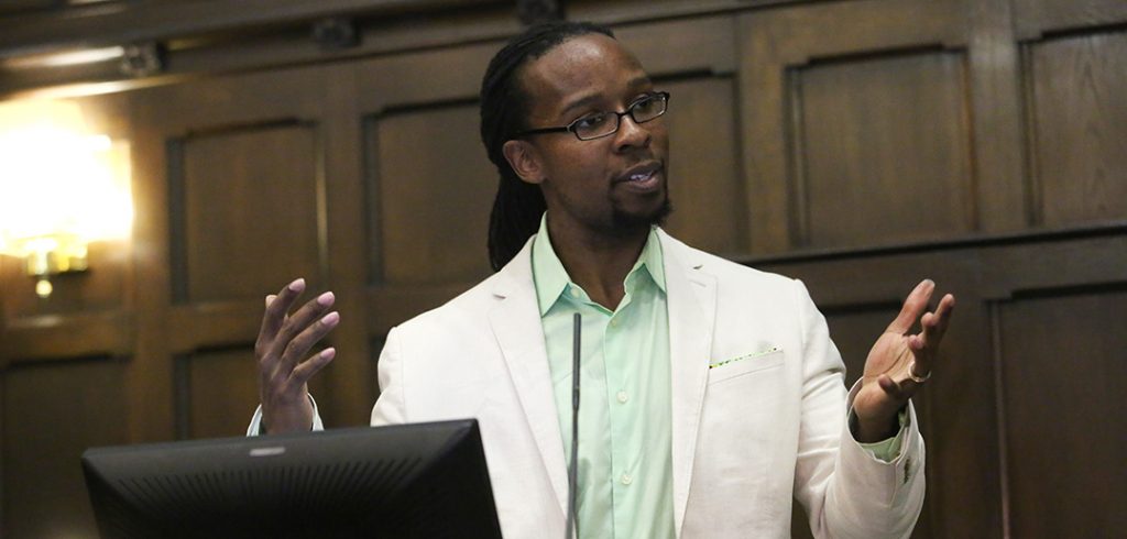 Ibram Kendi, Ph.D., speaks from behind a podium at Tognino Hall