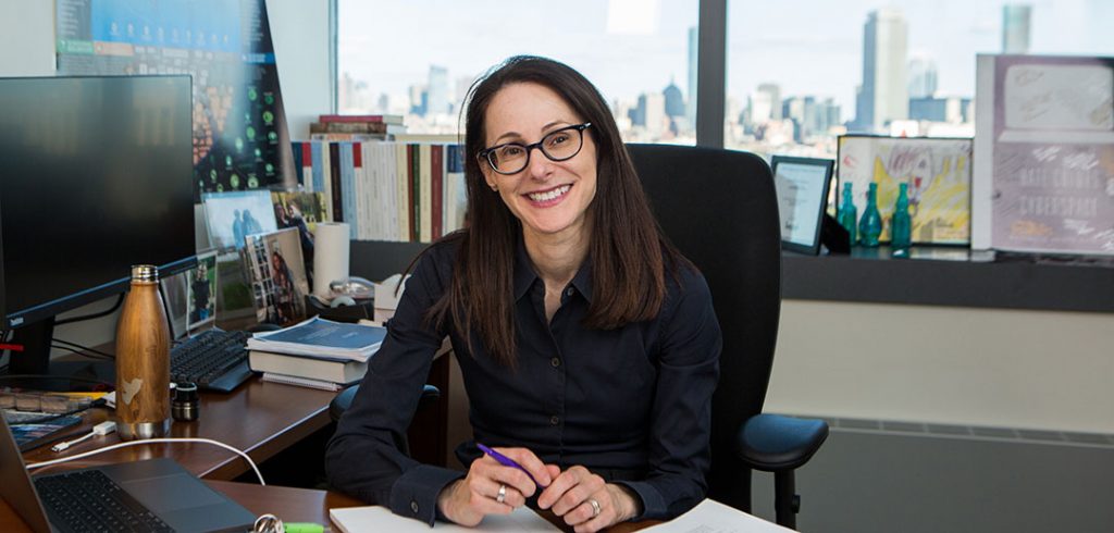 Fordham Law alumna Danielle Citron, a 2019 recipient of a MacArthur Foundation "genius" grant, sits at her desk at Boston University, where she is a professor of law.