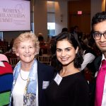 three women and a man posing