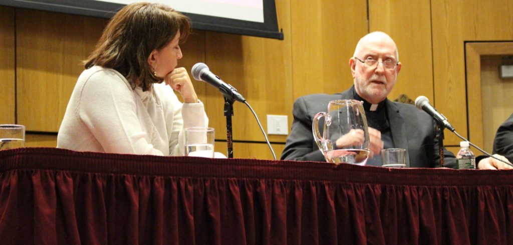 Two panelists talk at lecture