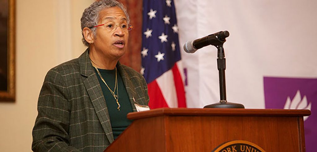 Deborah Watts speaking at a podium