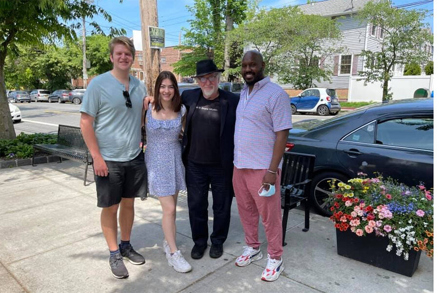Fordham students Carlos Rico (left) and Alison Rini, who helped launch the Bronx COVID-19 Oral History Project, stand with Professor Mark Naison, the project's faculty adviser, and Lionel Spencer (right), an artist interviewed for the project, outside the Crab Shanty Restaurant on City Island in the Bronx on May 20, 2021.