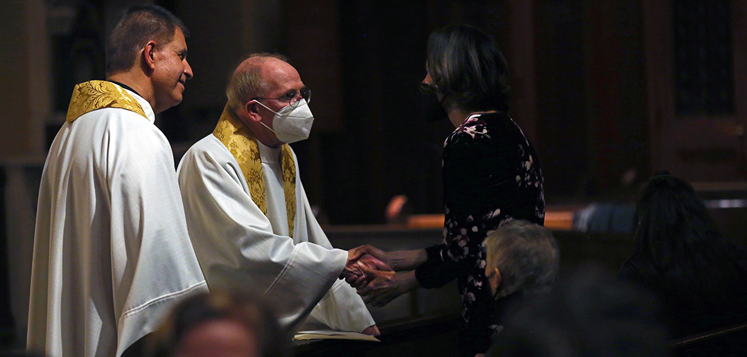 Dean Stovall's widow, Denise Herd, embraces his cousin Jack Smith at the memorial.