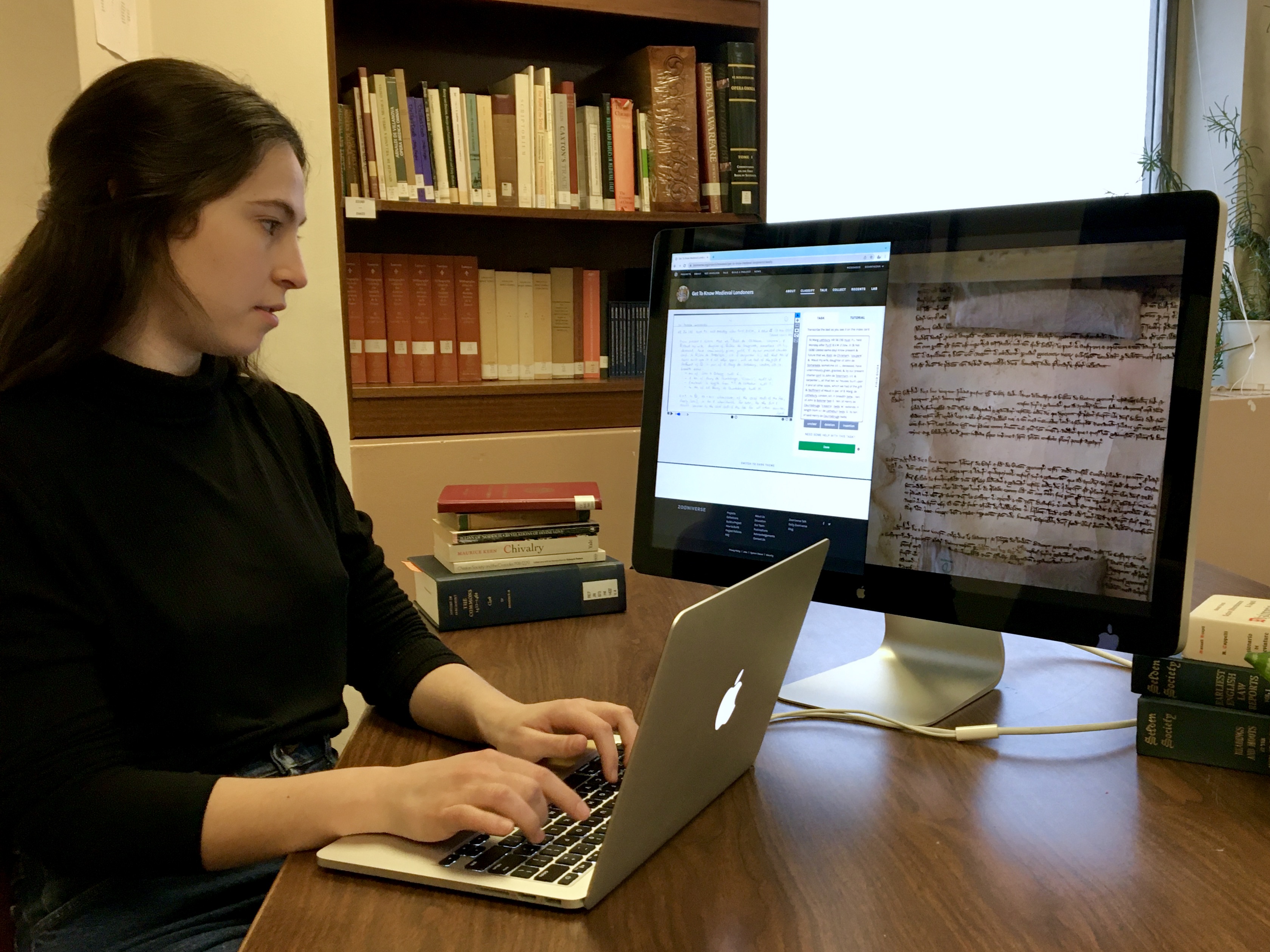 A girl types on a computer.