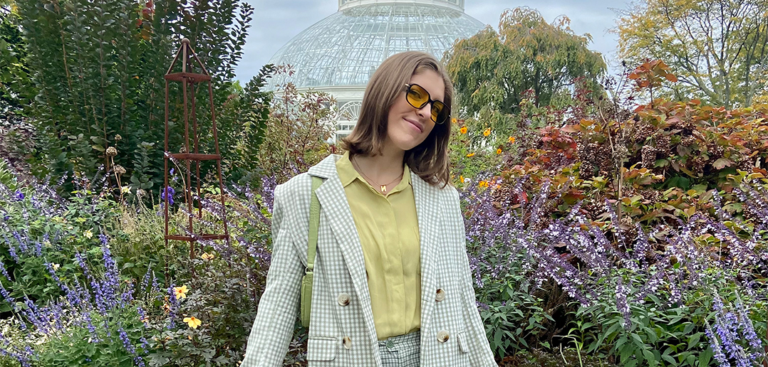 Isabelle Lee in front of flowers at the New York Botanical Garden