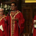 Mass celebrants in red robes on altar