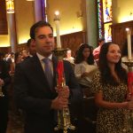 Student leaders process in church with candles