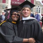 A pair of Fordham graduates hug after their graduation ceremony