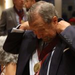 A man puts on his medal