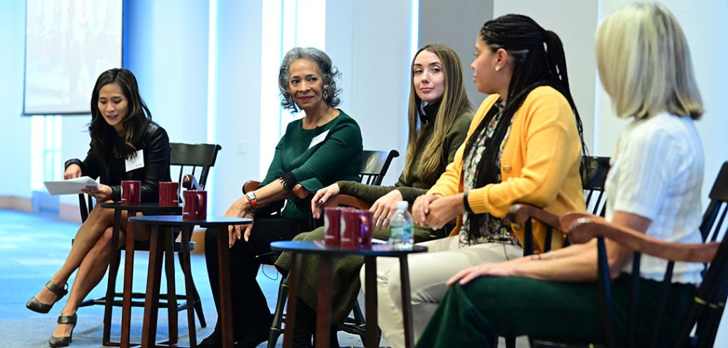 Women talk on a panel