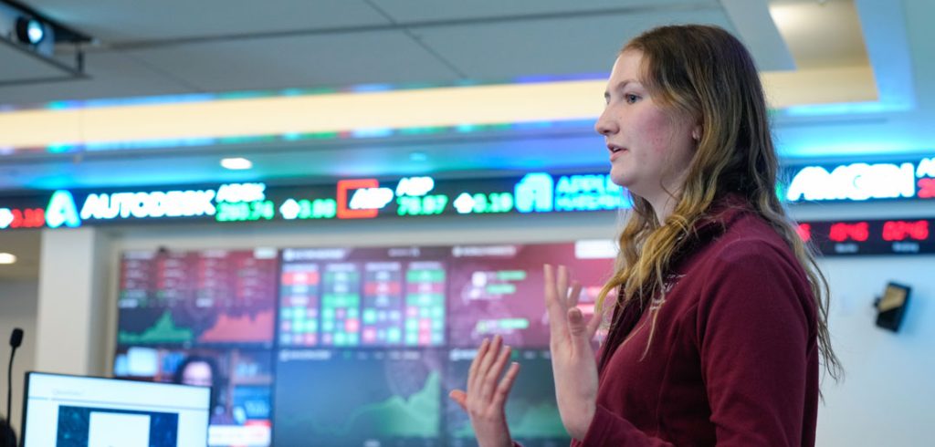 A student presents in the trading room