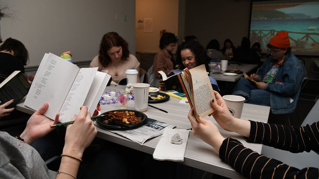 Students seated at tables, each reading their own book