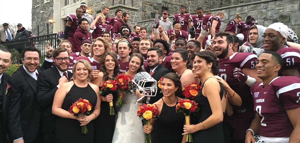 Christine Schwall-Pecci and her husband, Rob, with the Fordham football team in 2015