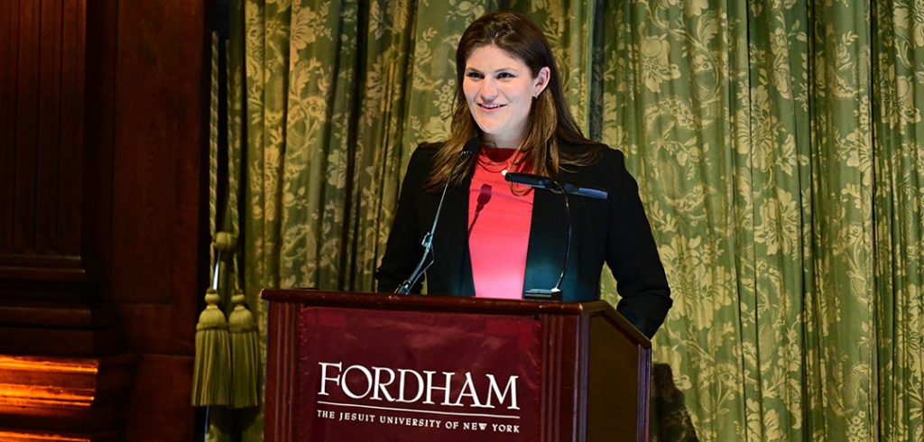 Female presenting student at podium