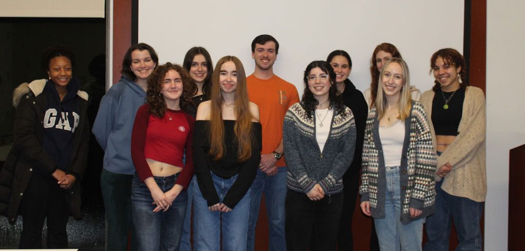 Large group of students standing together smiling for the camera.