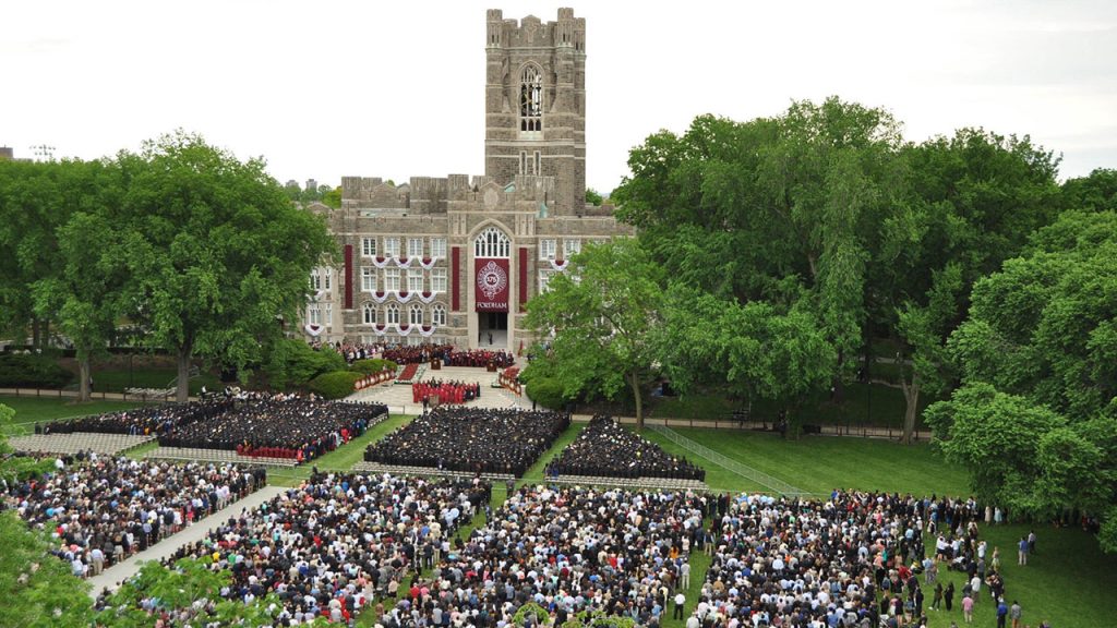 Edwards Parade filled with students on graduation day. Keating Hall in background.