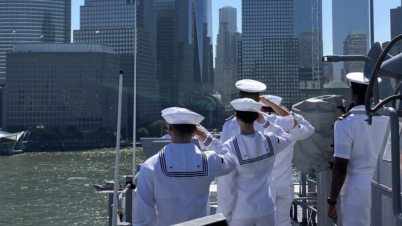 Marines and Navy sailors saluting the Freedom Tower from USS Bataan