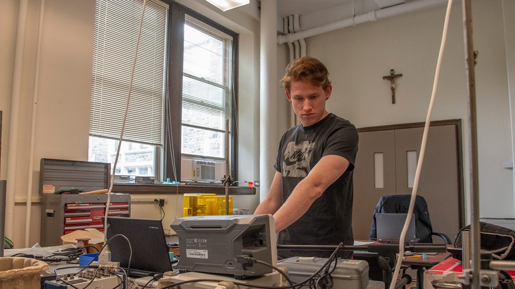 Jackson Saunders, a senior at Fordham, working in a lab at the Rose Hill campus