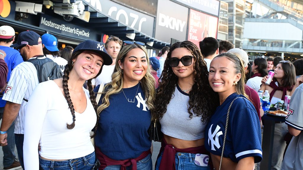 Four Yankees fans smile for a picture