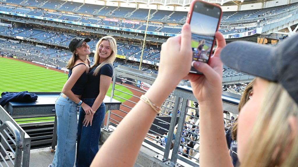 Two girls take a picture at Yankee Stadium