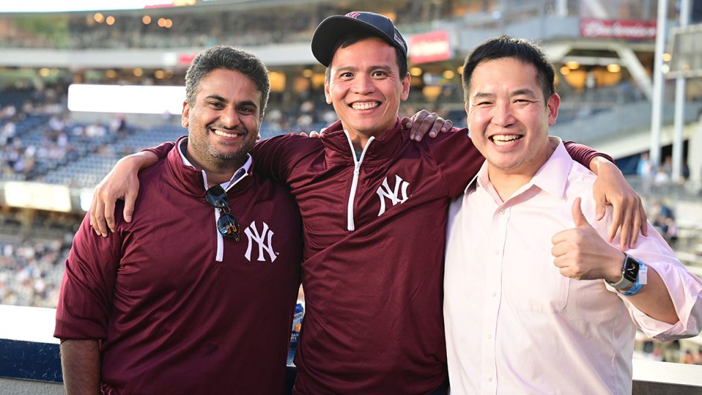 Three fans pose for a picture