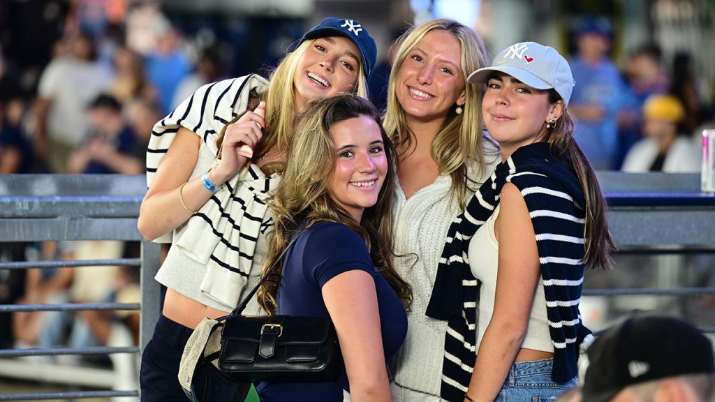 Four Fordham fans pose for a picture at Yankee Stadium.