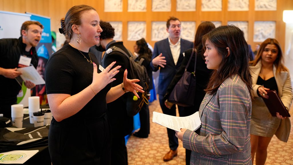 A student and a company representative speaking at a career fair at the McShane Campus Center