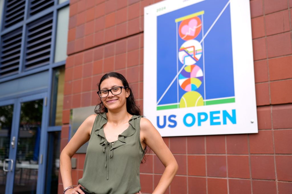 A woman standing next to a sign that says US Open