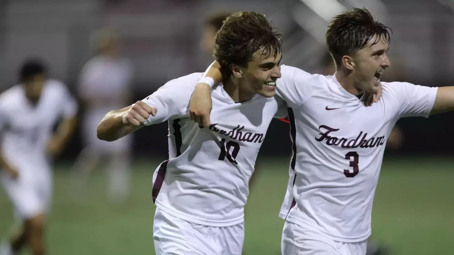 Daniel D’Ippolito with teammate in white Fordham uniforms