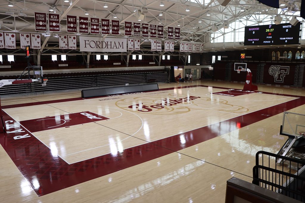 A view of the Rose Hill Gym floor with championship banners hanging from the rafters