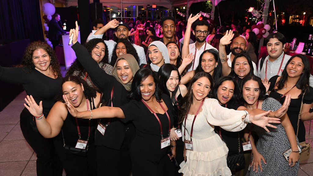 Group of men and women smiling. 