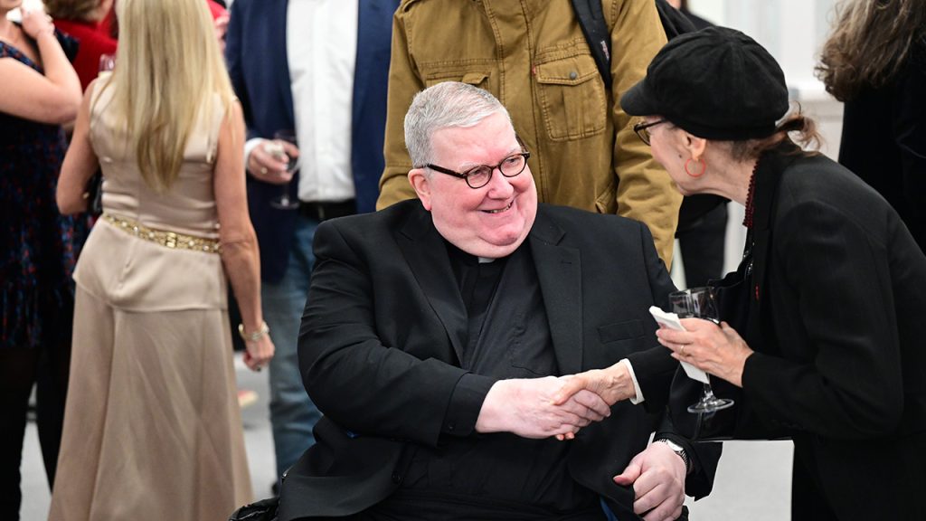 Father Grimes being congratulated at the dedication of new music rooms named for him