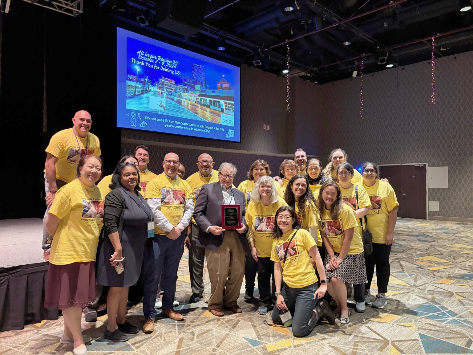 Salvatore Longarino holding his lifetime achievement award from NAFSA Region X in Atlantic City this fall, surrounded by his colleagues at Fordham and the many universities where his protégés landed. Photos courtesy of Salvatore Longarino