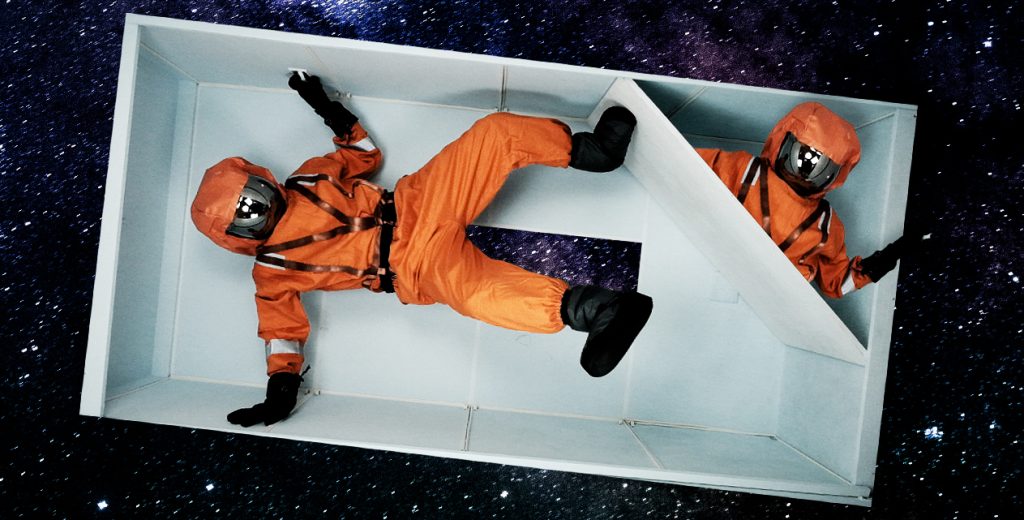 Two astronauts in white box in space