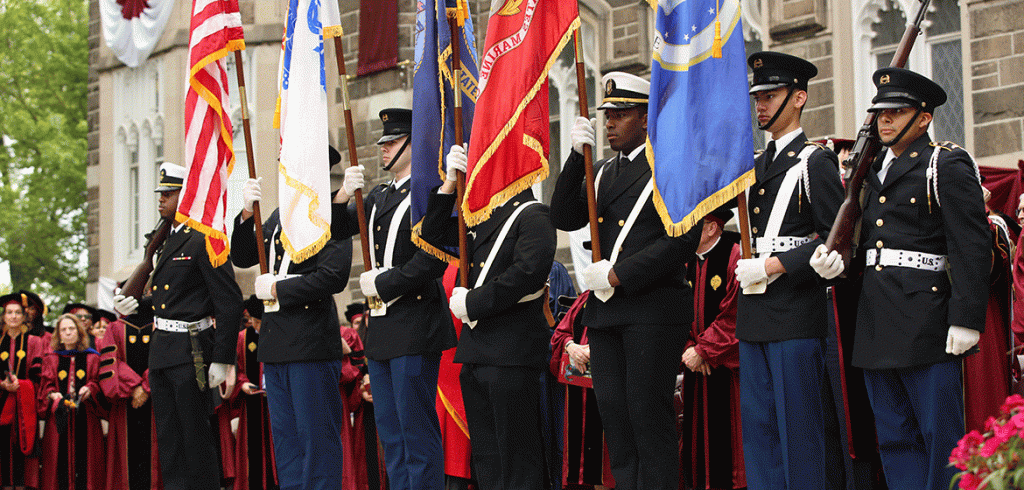 Members of the Army and Navy ROTC hold flags at Fordham's commencement ceremony 
