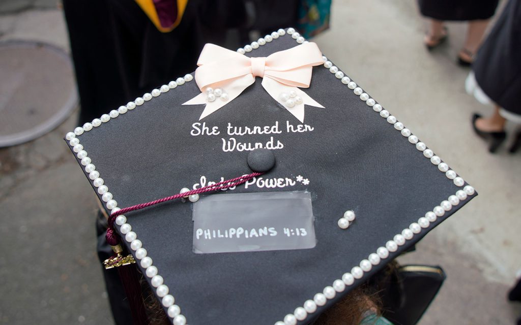 Commencement cap decorated with the message "She turned her wounds into power, Philippians 4:13"