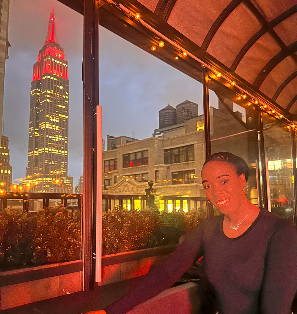 Woman posing with Empire State Building