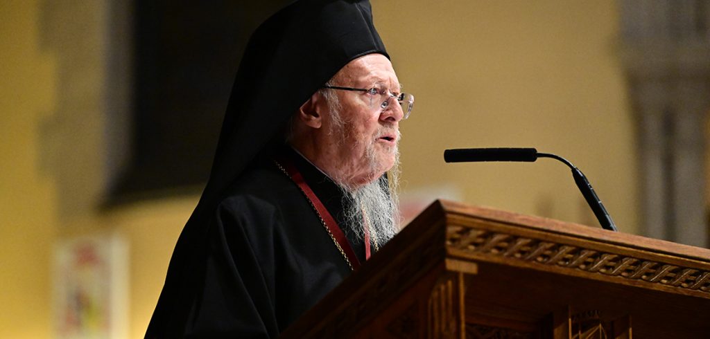 His All-Holiness Bartholomew, Archbishop of Constantinople-New Rome and Ecumenical Patriarch, speaks from a podium
