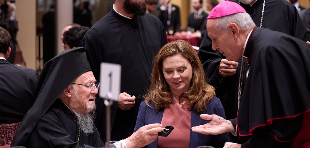 His All-Holiness Bartholomew, Archbishop of Constantinople-New Rome and Ecumenical Patriarch hands a piece of jewelry to Fordham president Tania Tetlow.
