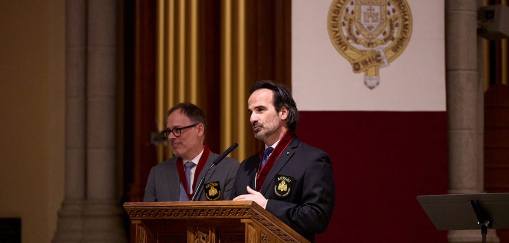 George Demacopoulos and Aristotle "Telly" Papanikolaou, co-directors of the Orthodox Christian Studies Center, standing at the podium in the University Church as Telly speaks.