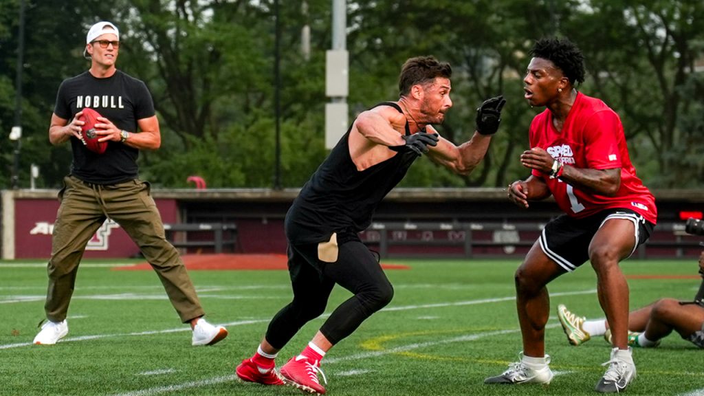 Danny Amendola runs toward Speed as Tom Brady prepares to throw the ball.