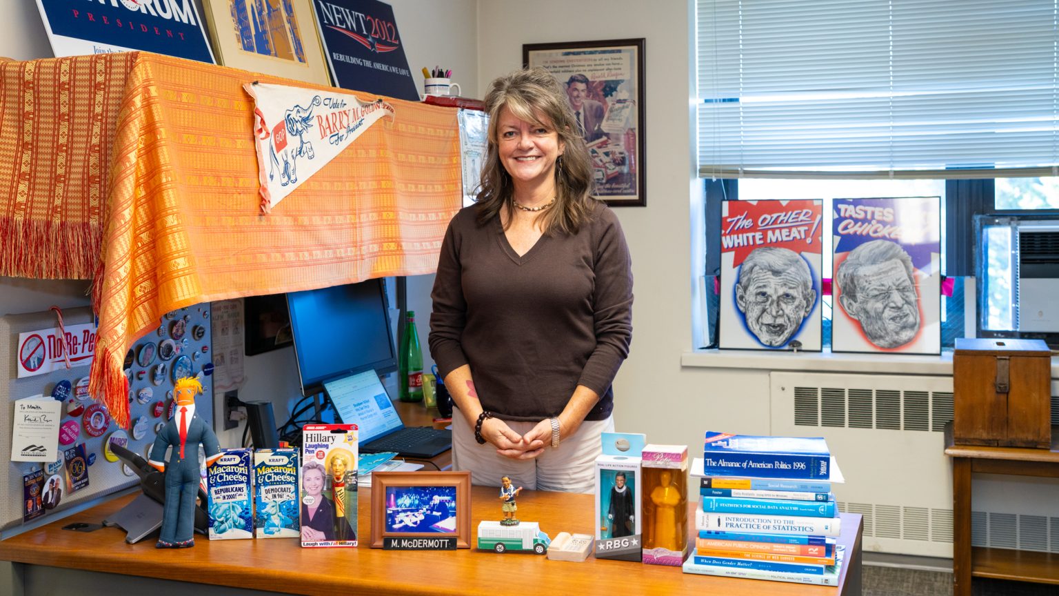 What’s on My Desk: Monika McDermott Monika McDermott stands and smiles in front of her desk.
