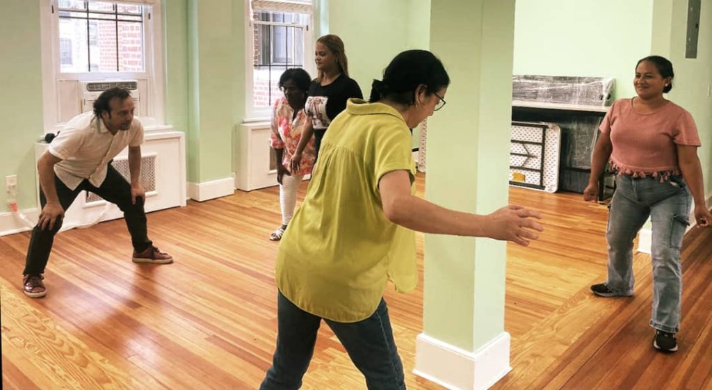 Fadi Skeiker leading an exercise during the applied theater workshop he led for members of Grupo de Mujeres Latinas.