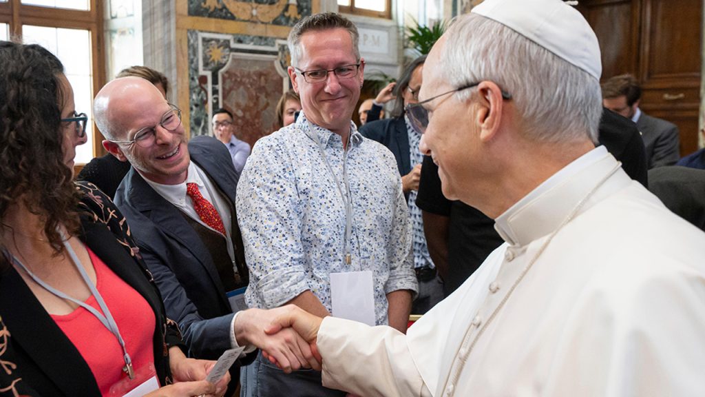 Fordham communications professor Gregory Donovan shaking hands with Pope Leo.