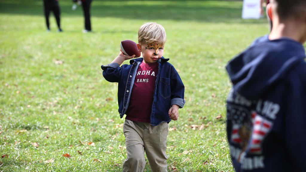 A young boy throws a football